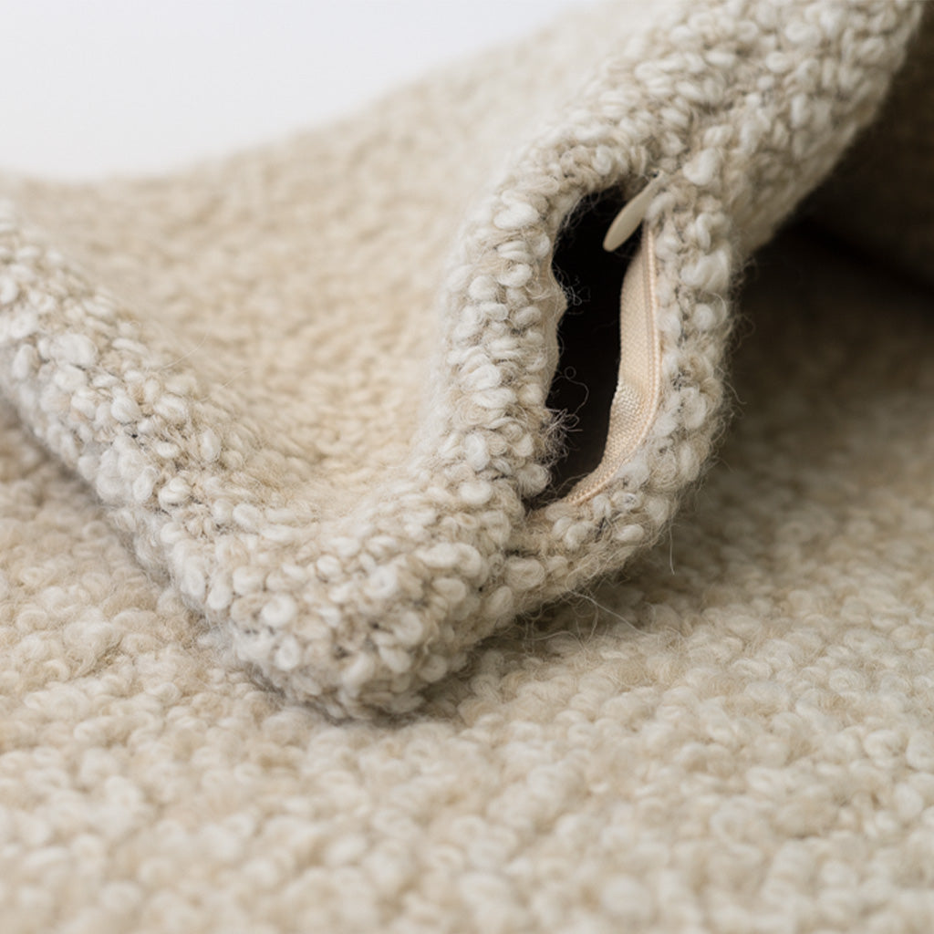 Alpaca and wool boucle pillow in a neutral tone, inspiration for the "Remaining Light" encaustic art piece