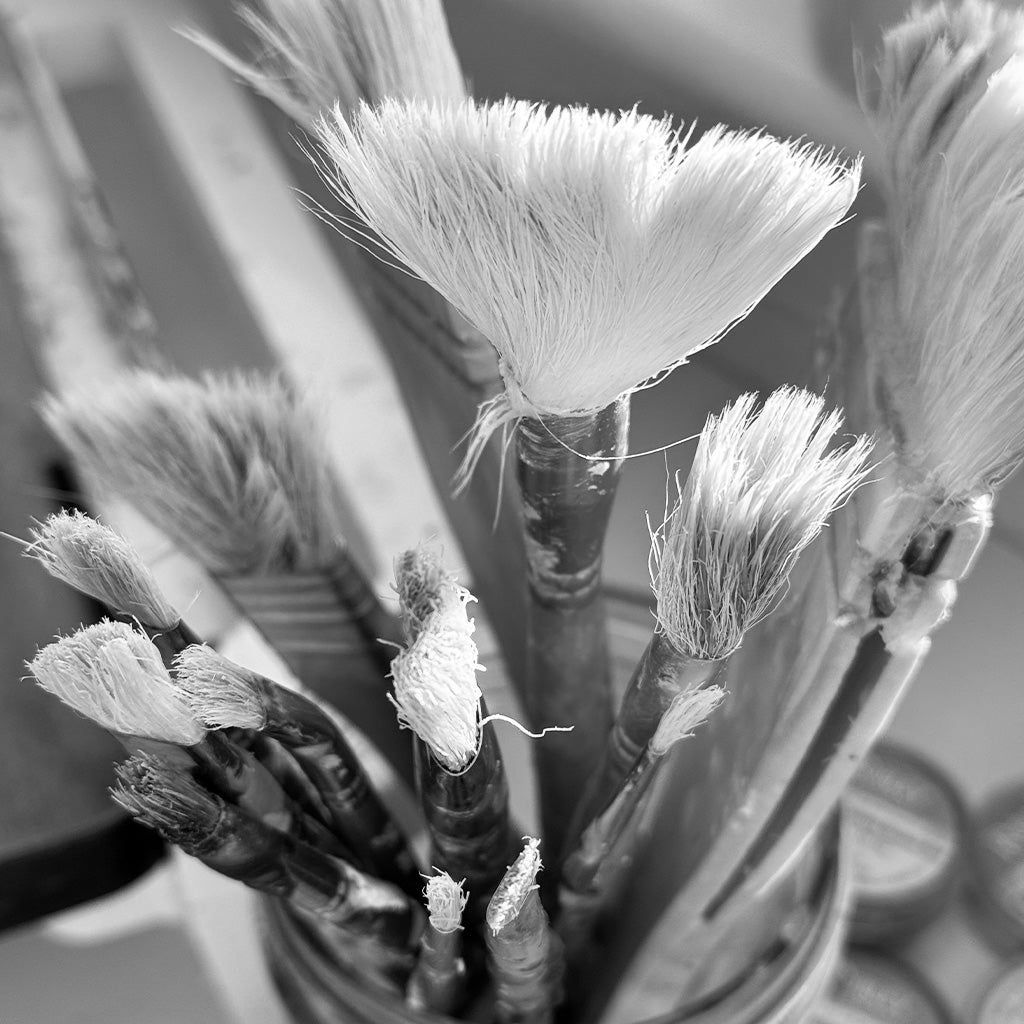 Black and white photograph of paint brushes with wax  remnants, ADALÉI material practice, Raleigh NC