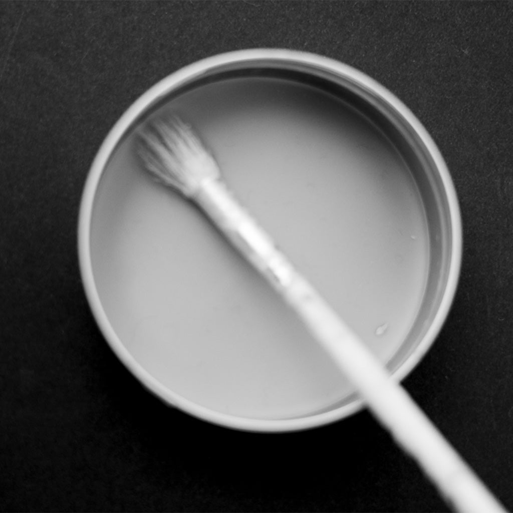 Black and White photograph of paint brush in encaustic wax for painting.