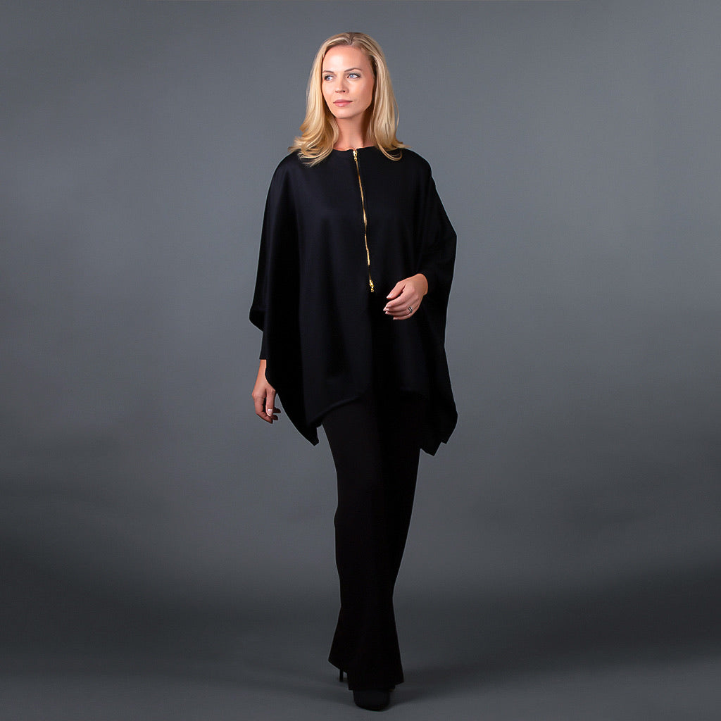 Front view of black cashmere wool cape with brass zipper